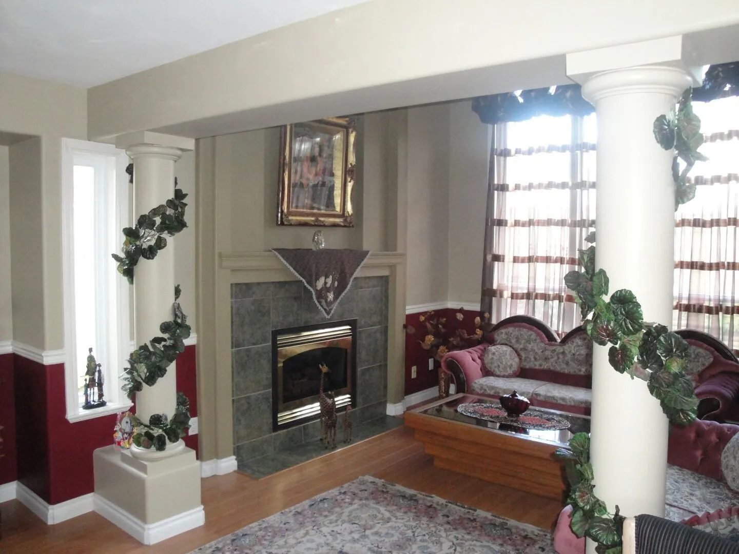 Living room with painted columns, chair rail and a two-tone wall